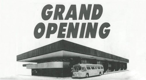 Black and white graphic with the words Grand Opening above a bus station with a bus parked nearby